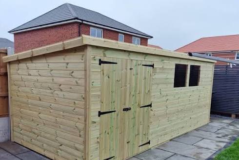 Long timber workshop shed with double doors